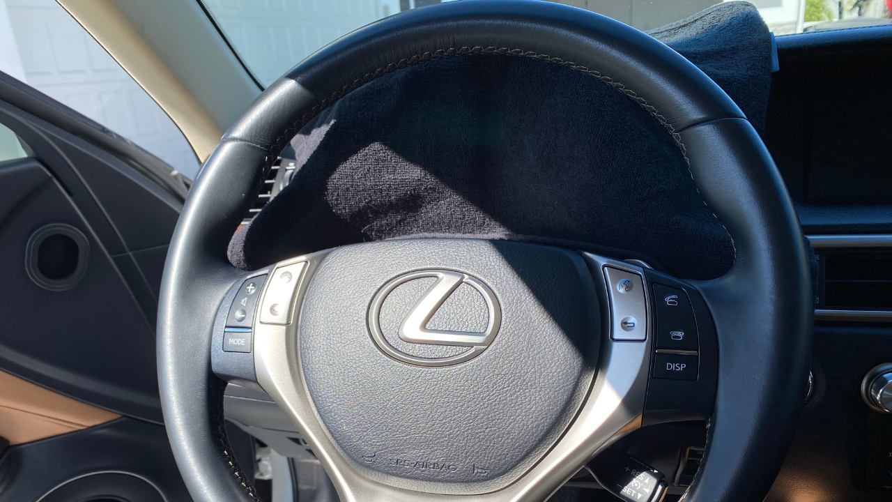 Lexus steering wheel with dashboard cluster covered by a towel